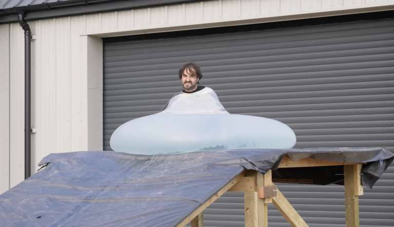 Man rolls downhill in giant water balloon in glorious slow motion
